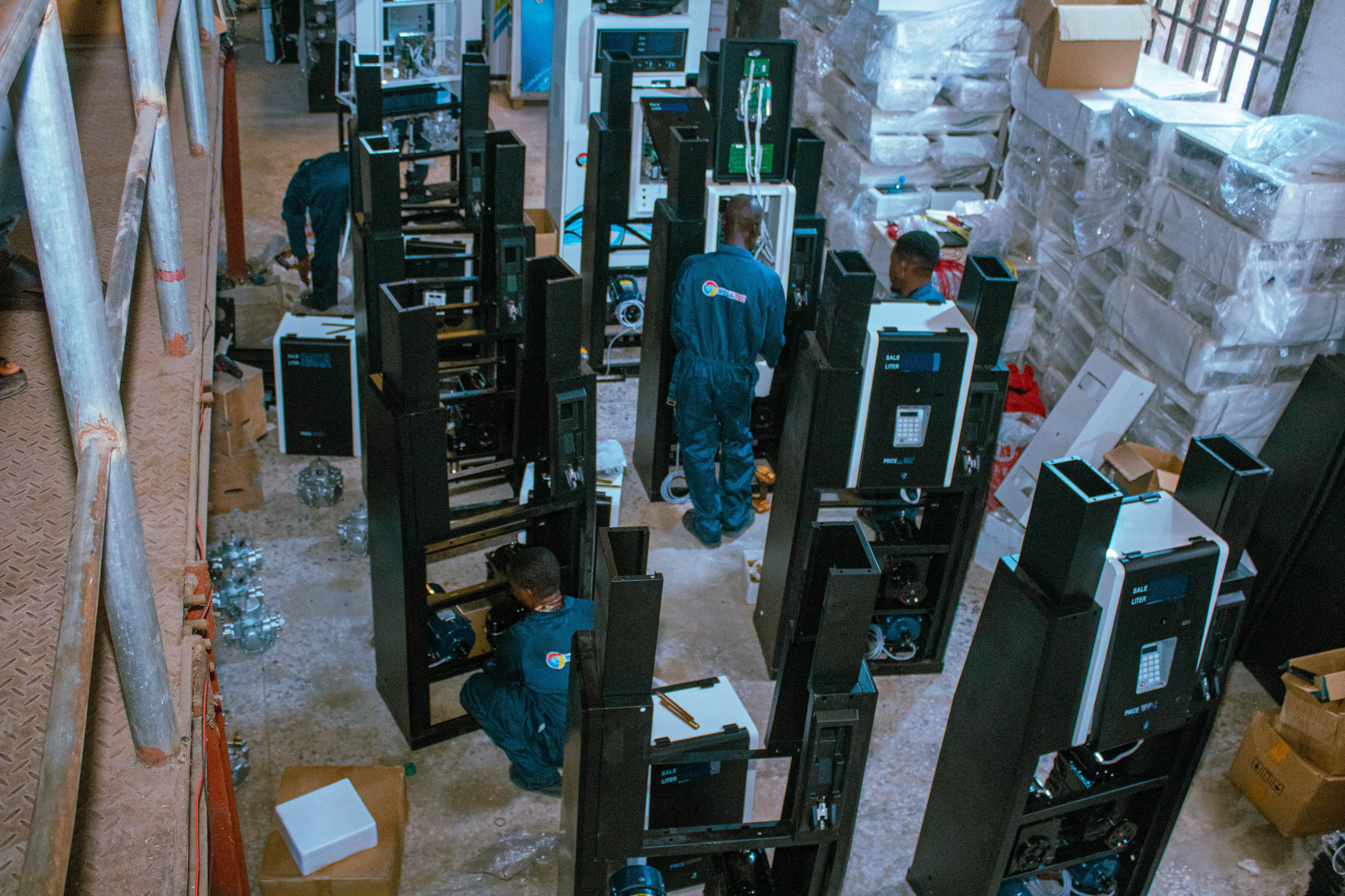 MEGA-TEC technicians assembling fuel dispensers on the assembly floor
